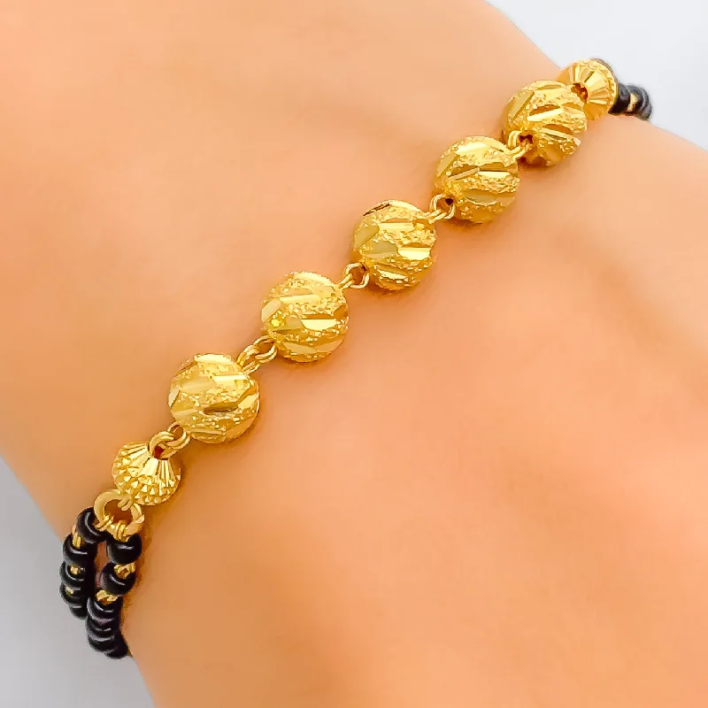 Women’s chain bracelets-Stylish Etched Orb 22k Gold Black Bead Bracelet